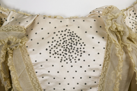 Wedding dress, 1894 (front detail view of sequins at neckline), Silk satin, chiffon, lace, metal sequins, wax blossoms, White, Howard & Co, Chicago and New York