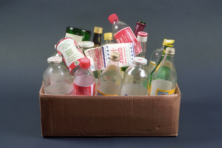 Box with empty bottles and other containers, objects..., 1992 (photo)