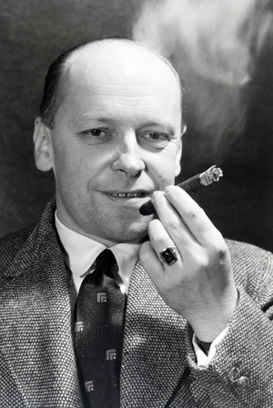 A man smoking a cigar for an advertising campaign, Germany 1930s (b/w photo)