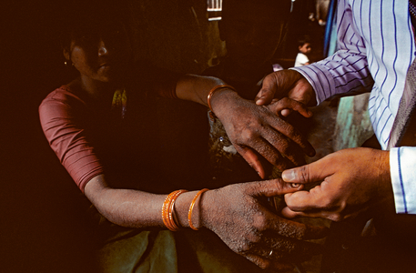 Doctor in Bombay Examing Warts on Sex Worker's Hands, 1994 (photo)