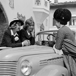 Two women getting a drink by a woman in Black Forest array, Germany 1930s (b/w photo)