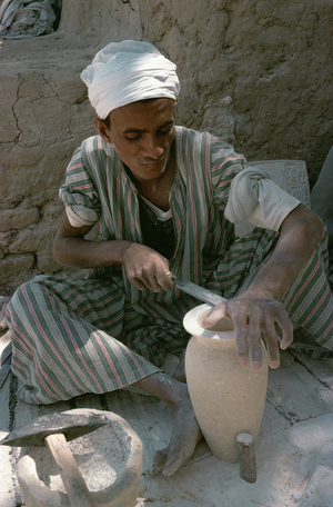 Stonecutter polishing an alabaster vase, Luxor, Egypt (photo)