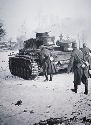 Infantry in greatcoats advance behind Pzkw III tank, during the German invasion of Russia, winter 1942 (b/w photo)