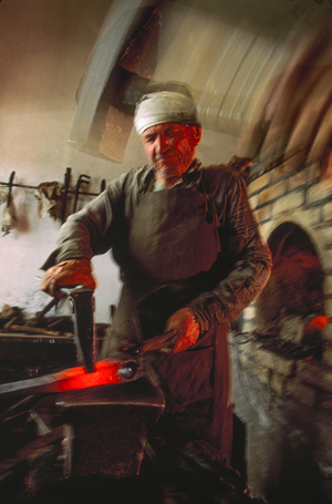 A blacksmith plies his ancient trade in Samark,. Samark, Uzbekistan., 1990s (photo)