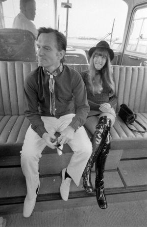 Hugh Hefner and Barbi Benton in an airport shuttle bus, 1970 (b/w photo)