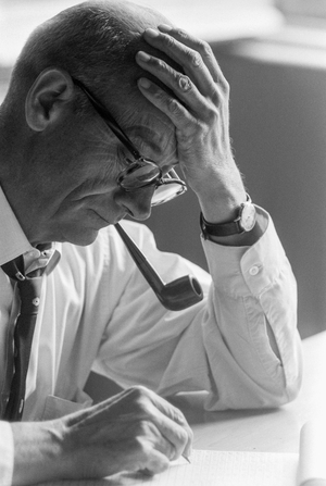 Dr. Benjamín Viel, Chilean doctor studies a document. and smokes a pipe., 1967 (photo)