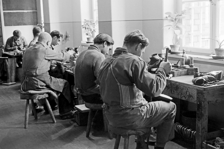 Original caption: Some boys leave the young offenders institution with an apprenticeship – Their education ends with a trade test that they can catch up with life through hones working - View to the bootmaking, Germany 1950