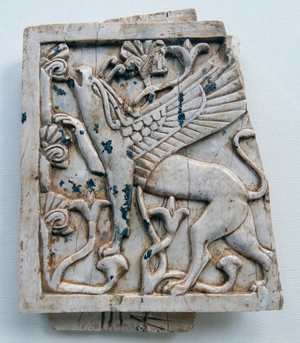 Ivory depicting a griffin eating leaves from a tree