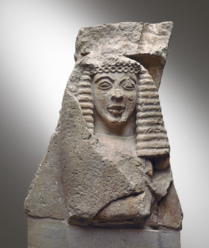 Fragment of metope with female figure, -630 (Poros, local limestone)