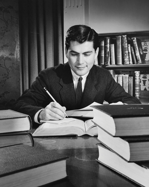 Businessman writing on a sheet of paper and smiling
