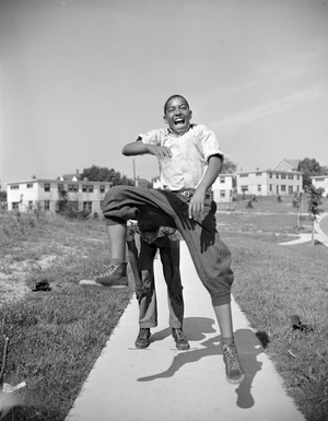Boys playing leap frog near the project, Frederick Douglass housing project, Anacostia neighbourhood, Washington D.C., 1942 (b/w photo)