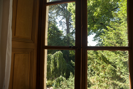 Nohant. The castle of George Sand (Le château de George Sand). Interior. View of the garden trees through a window.