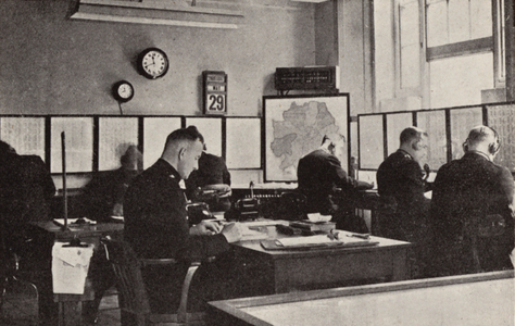 Information room at Scotland Yard, London, where policemen receive 999 calls (b/w photo)