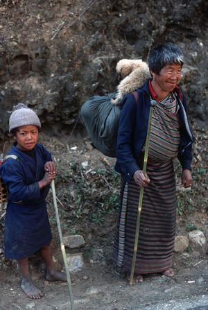 Bhutanese family with puppy, Bhutan, Himalayas (photo)