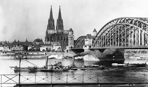 Official photograph taken on the British Western Front showing city with river and bridge, 1917-1918 (photograph)