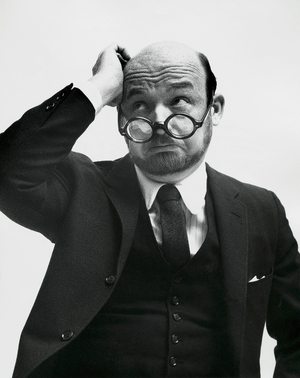 Close-up of a businessman scratching his head and thinking