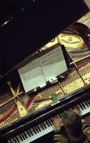 Close-up of a piano keyboard. Contemporary music performed by the Ensemble Intercontemporain, Paris 2009. (Trumpet being  played into a grand piano).