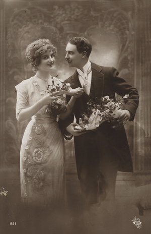 Couple holding shoes filled with flowers (b/w photo)