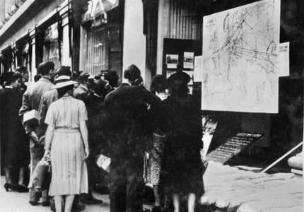 Passers-by look at a map of Europe, England, 1939 (b/w photo)