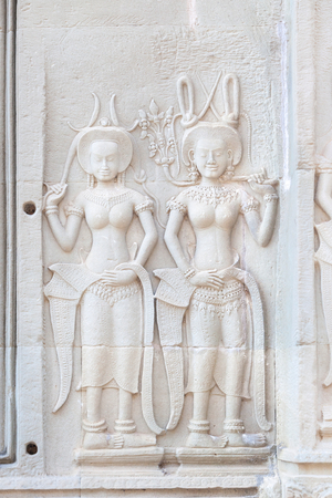 Bas relief of two Apsaras at Angkor Wat, Siem Reap, Cambodia (photo)