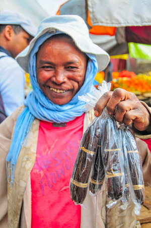 Bourbon vanilla; vendor with vanilla pods at Analakey Market, Antananarivo, Madagascar 