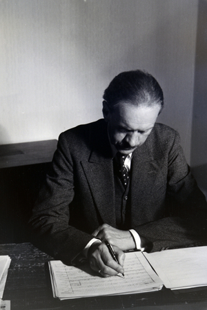 Portrait of one of the Diehl brothers and founders of the hedgehog character Mickie working on the skript of the animated movie The Race between the Rabbit and the Hedgehog, Germany 1930s (b/w photo)