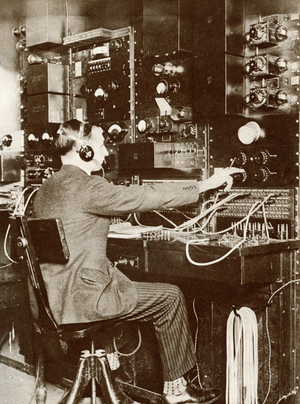 An English switchboard operator speaking to America by radio telephone for the first time in 1926.  From The Story of 25 Eventful Years in Pictures published 1935