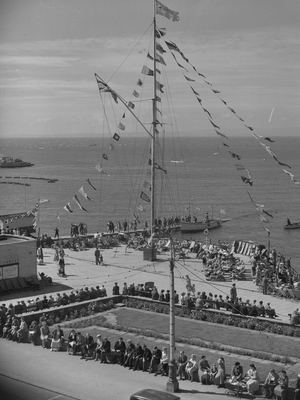 A very busy scene of a large number of people sat at a promenade in Morecombe, 1930s-60s (b/w photo)