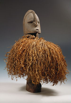 Female fertility figure, wooden statue with a big  belly of clay under the straw skirt (mixed media)
