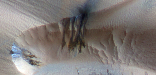 Three images of the same location taken at different times on Mars show seasonal activity causing sand avalanches and ripple changes on a Martian dune. HiRISE.