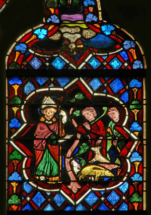 Scene in the E window depicting St Samson changes pigs into goats (stained glass)