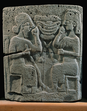 Two banqueters (bas relief)