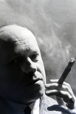 A man smoking a cigar for an advertising campaign, Germany 1930s (b/w photo)