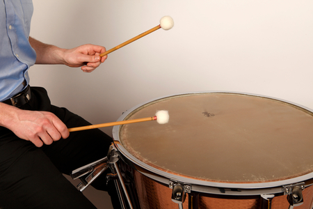 Timpani sticks or beaters in playing position on a calf headed timpani