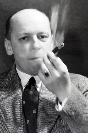 A man smoking a cigar for an advertising campaign, Germany 1930s (b/w photo)