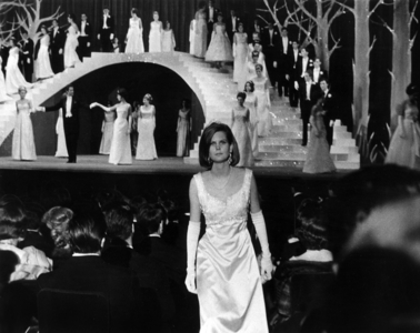 Ball of The Debutantes in Chaillot Palace in Paris on November 20, 1963 : Jacques Chazot (Master of Ceremony) With 2 Debutantes Under The Staircase (b/w photo)