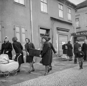 We Need This', Group of women carrying provisions back home, 1944-46 (b/w photo)