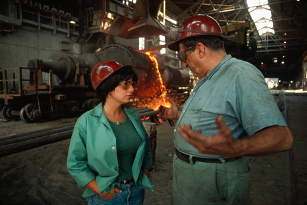 A young woman supervises this worker in moving pig iron at Aliquippa., 1977 (photo)