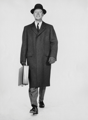 Studio portrait of businessman carrying briefcase