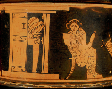 Open door showing bed and young woman with mirror …
