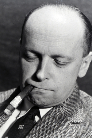 A man smoking a cigar for an advertising campaign, Germany 1930s (b/w photo)
