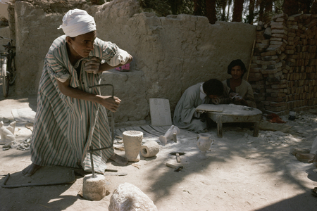 Stonecutter polishing alabaster objects, Luxor, Egypt (photo)