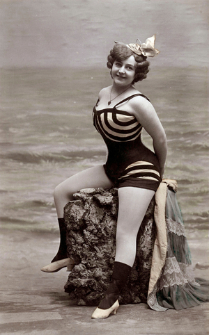 A bather wearing a bathing suit on a rock, postcard, c. 1910