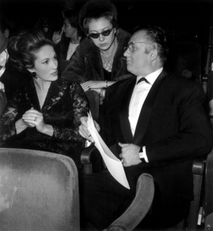 French Actor Jean Richard and his Wife at Concert of Charlesaznavour at The Olympia in Paris, 1965 (b/w photo)