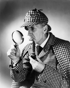 Mature man dressed as Sherlock Holmes (b/w photo)