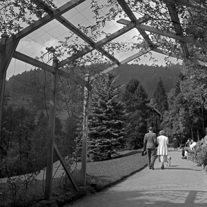 A couple strolling through an access balcony at Wildbad in Black Forest, Germany 1930s (b/w photo)