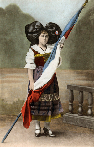 A woman from Alsace with traditional costum holding french fla (postcard)