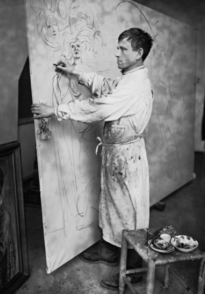Otto Dix in his studio in Berlin while composing one of his oil paintings, 1930s (b/w photo)