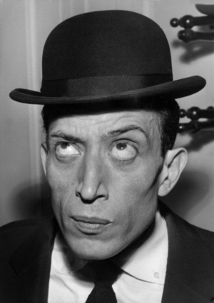 French Actor Philippe Clay Trying on Bowler Hat in A Shop in Paris For his Next Film Toto in Paris, May 13, 1958 (b/w photo)