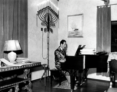 George Gershwin (1898-1937) American composer and pianist, smoking and playing the piano